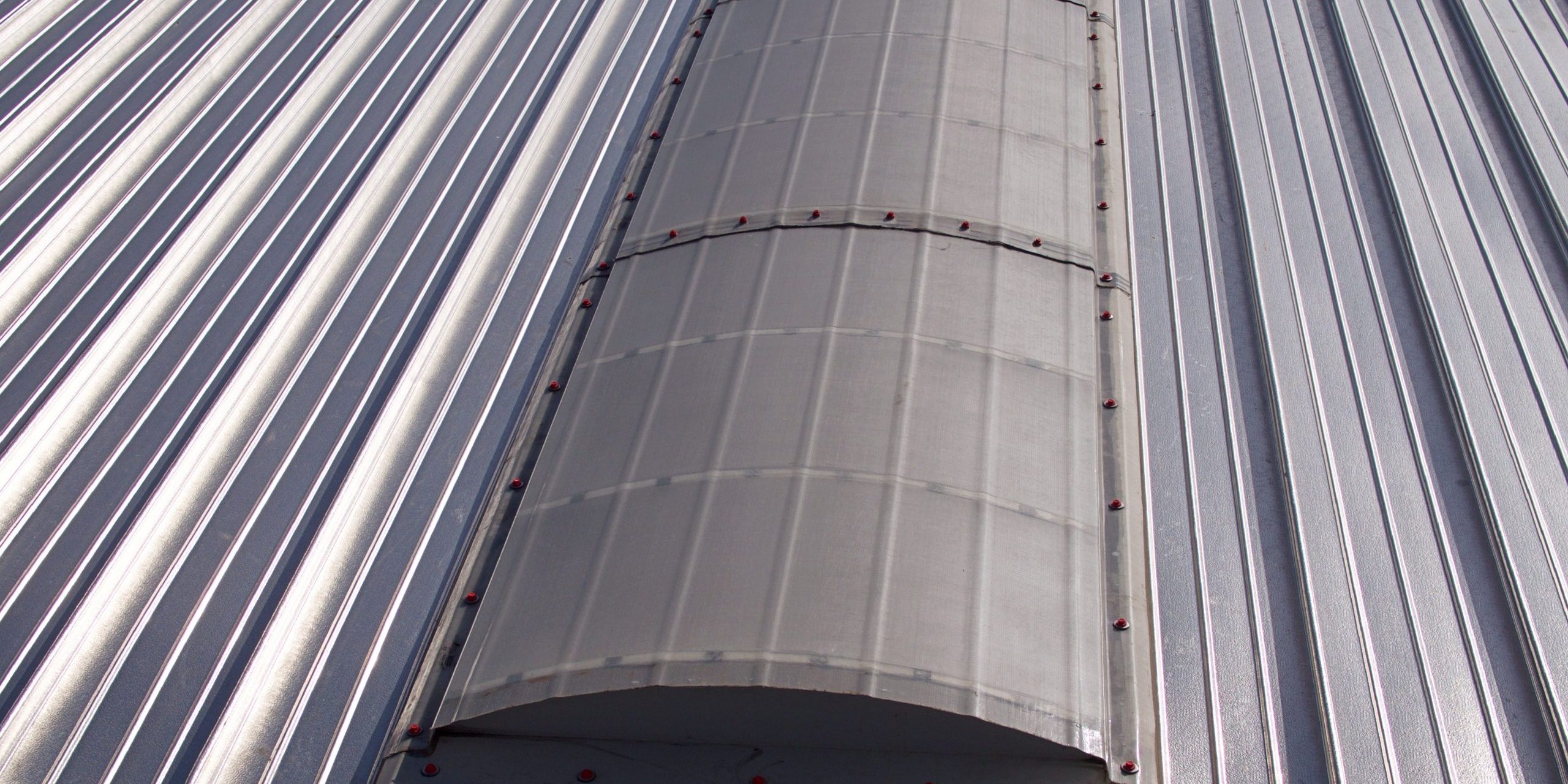 Monarch F on a Standing Seam Roof Continuous barrel vaulted GRP rooflight